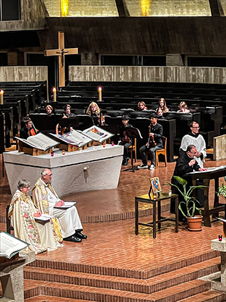 Three volumes of The Saint John's Bible Heritage Edition lay open in the saint john's abbey