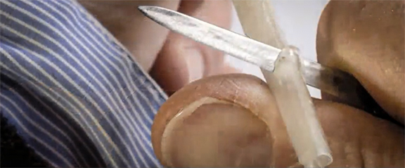 Donald Jackson has his pen knife angled towards his body, allowing him to make an exact shoulder cut along the barrel of the feather (7:16).