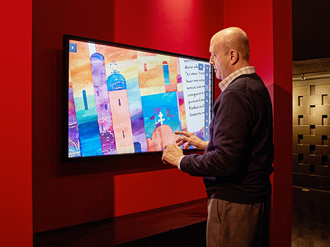 Ternes zooms in on an illumination in The Saint John’s Bible gallery at the Hill Manuscript Museum and Library in Collegeville, Minnesota.