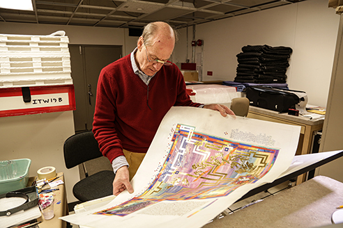 Donald Jackson, creator of The Saint John’s Bible, inspects an illumination prior to completion. 