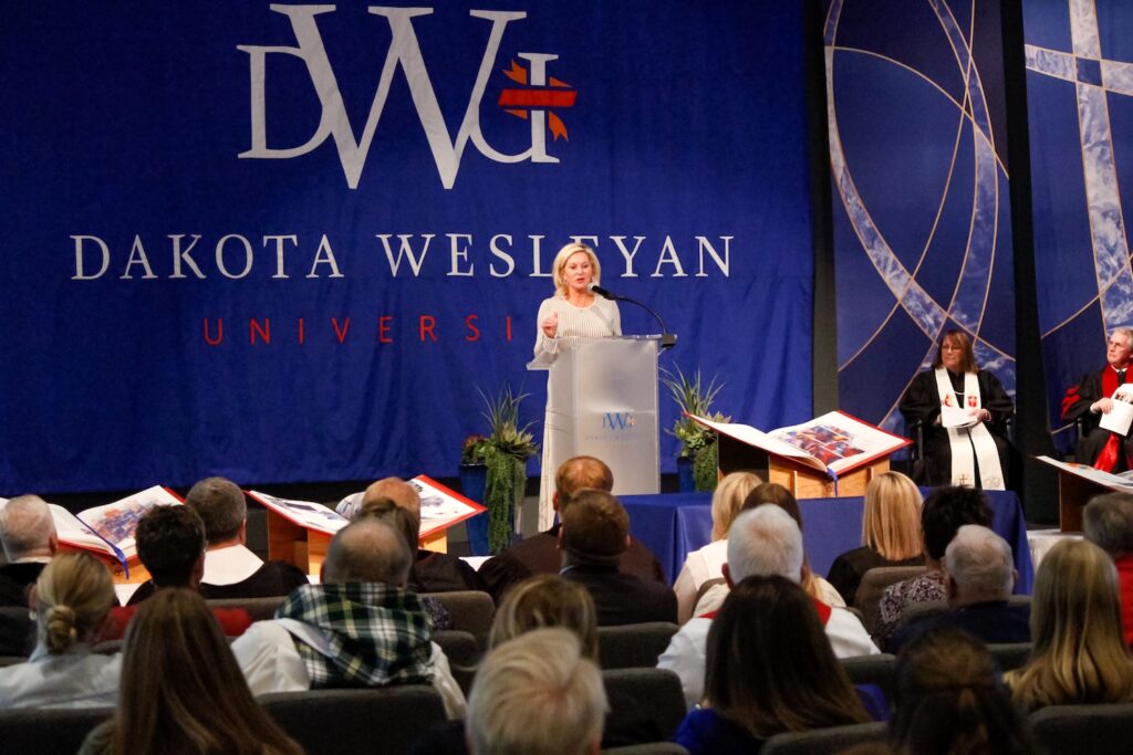 Kathy Ramstad speaks at the blessing and dedication of the Heritage Edition at Dakota Wesleyan University, which was gifted in honor of her mother.