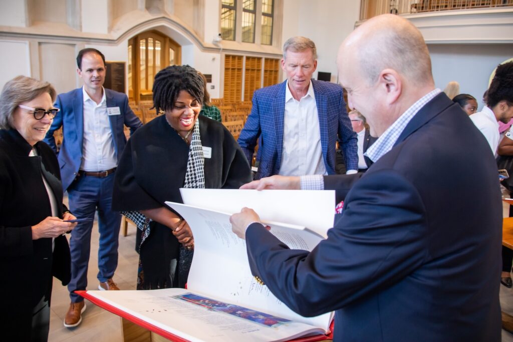 Ken Krebs (second from right) and other Duke Divinity School leaders experience Tim Ternes, Curator of The Saint John’s Bible, turning the pages of The Saint John’s Bible Heritage Edition gifted by Krebs.