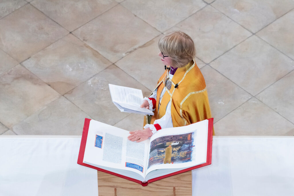 The Most Rev. Sarah Mullally, Archbishop of Canterbury, lays her hand on a volume of the Heritage Edition of The Saint John’s Bible as she swears her Corporal Oath. 