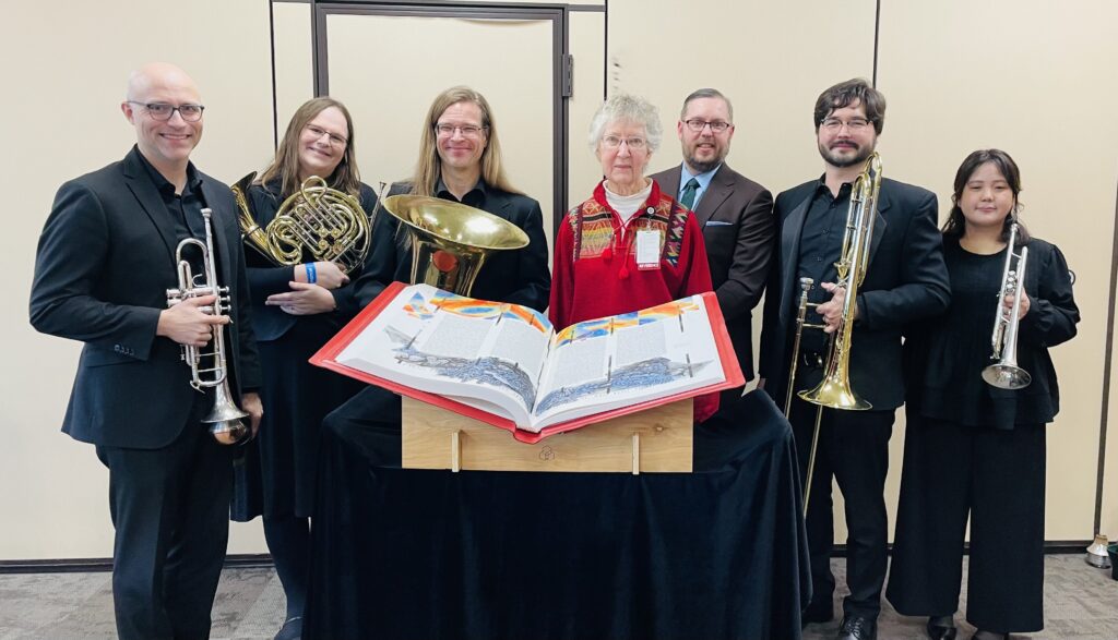 Members of the Boise Philharmonic stand with Sister Beth and Brandon VanWaeyenberghe, Executive Director of the Boise Philharmonic, behind the Heritage Edition. 
