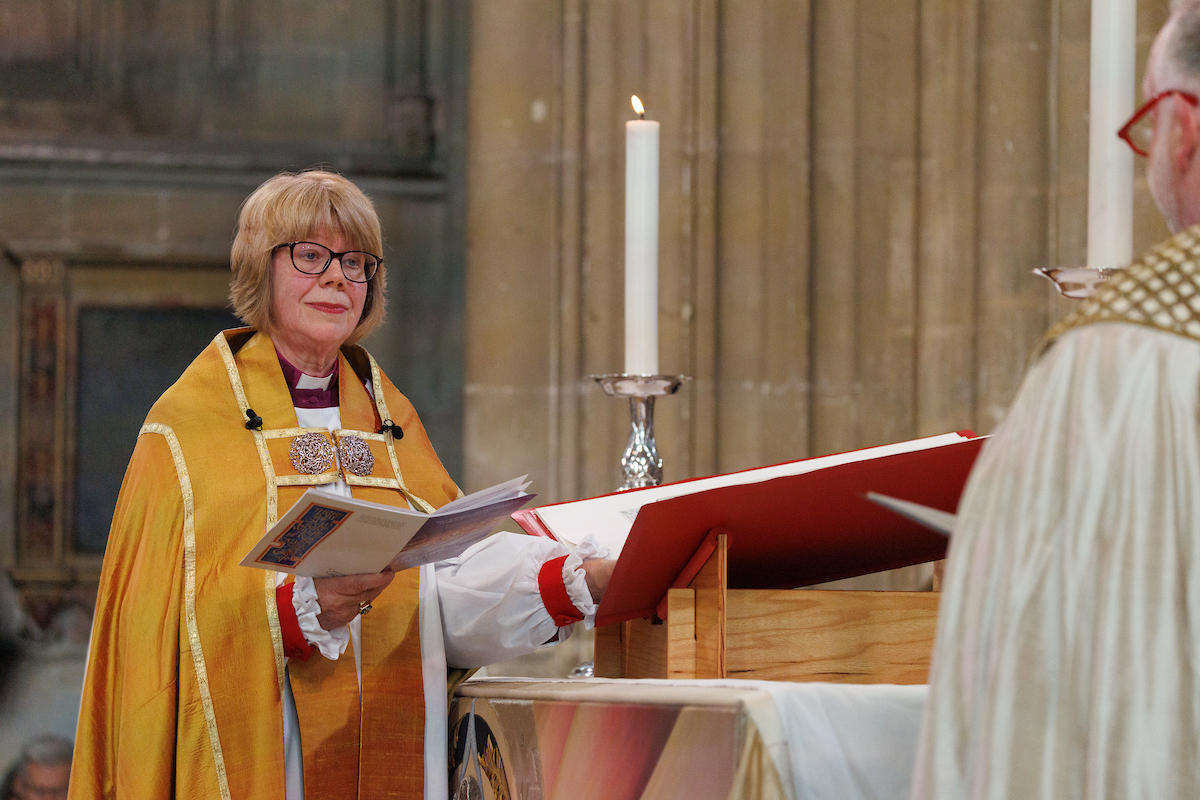 The Most Rev. Sarah Mullally, Archbishop of Canterbury, lays her hand on a volume of the Heritage Edition of The Saint John’s Bible as she swears her Corporal Oath.